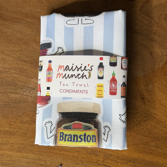 Condiments tea towel folded in its Maisie's Munch paper band
