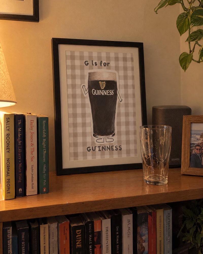 Framed G is for Guinness print on a bookshelf