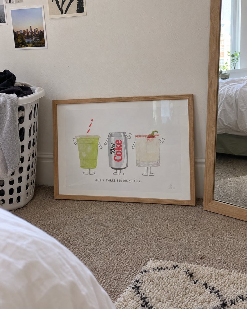 Framed Three Personalities print leaning against a bedroom wall